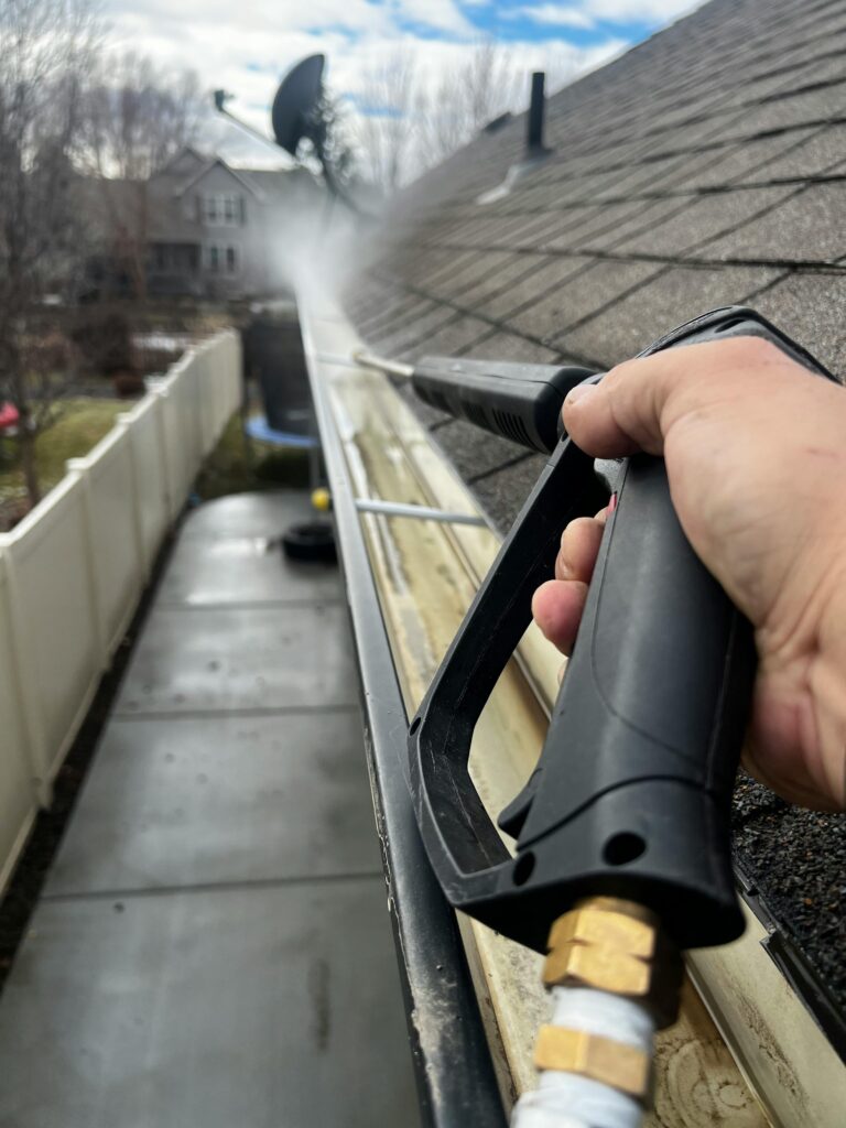 Cleaning roof gutters to prevent water damage