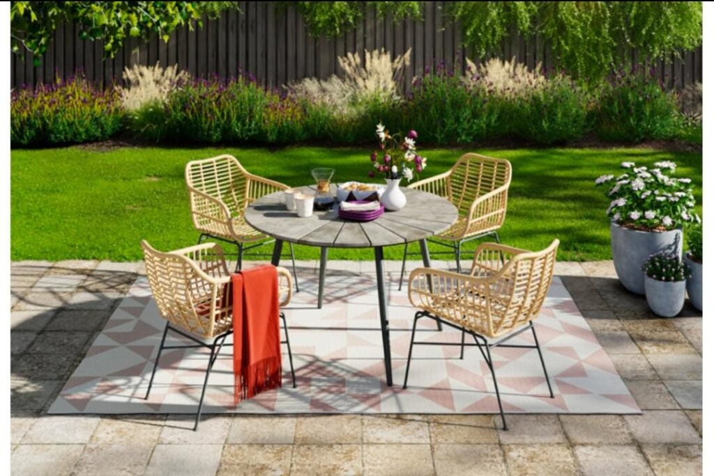 Outdoor rug decorating small backyard patio area